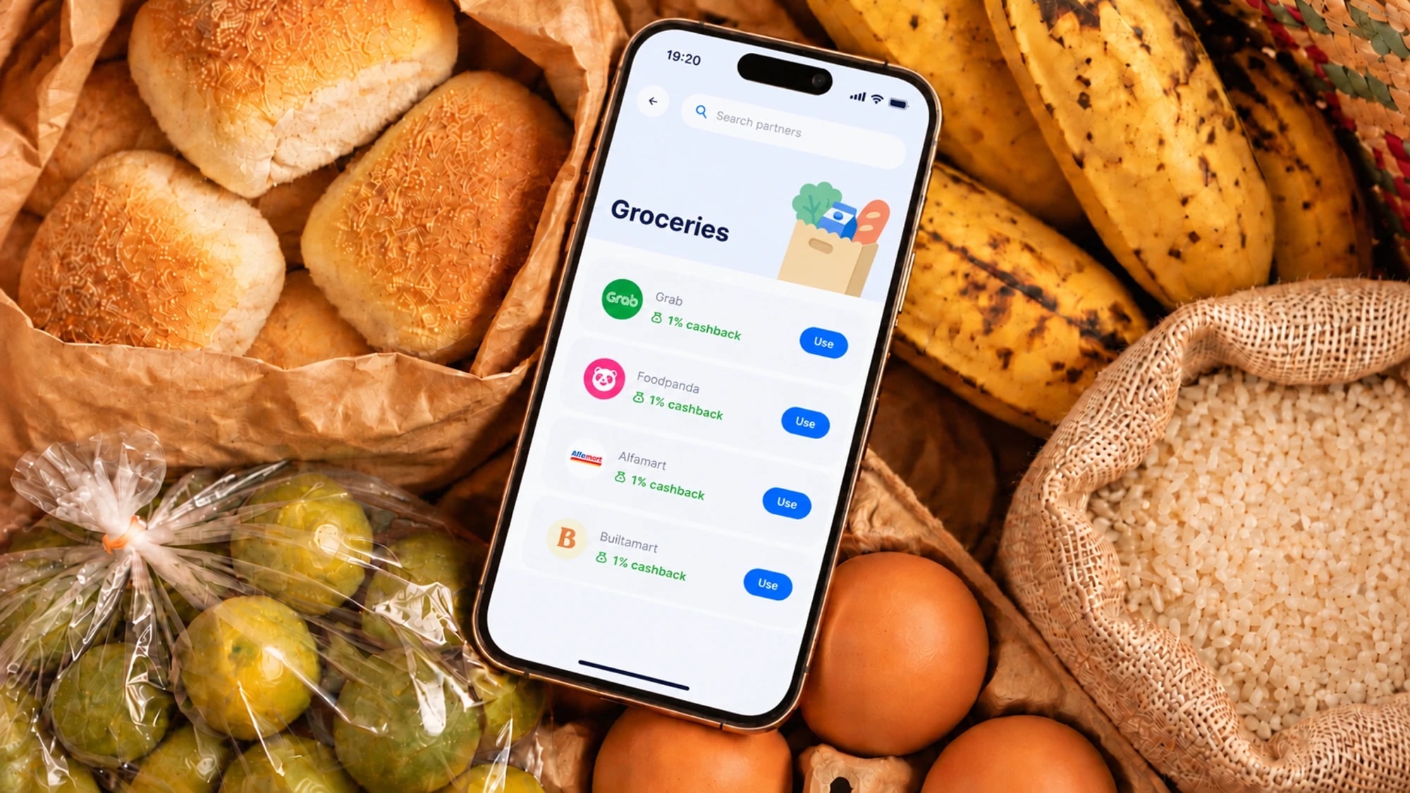 Uno grocery cashback partners on a phone among groceries